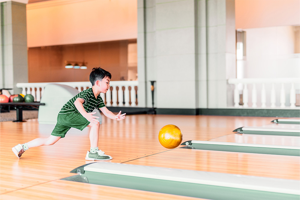 A kid bowling in Dubai Bowling Centre 