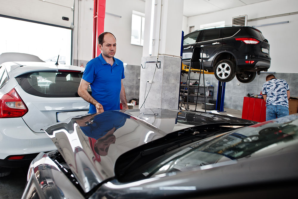 Mechanic checking a car for repairing