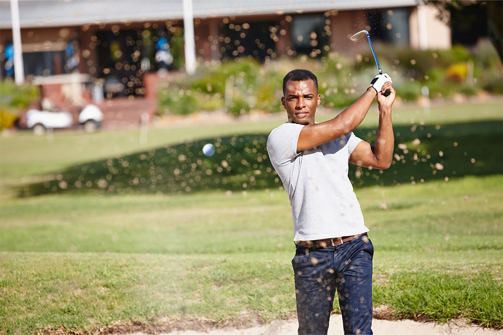 A man playing golf at Abu Dhabi City Golf Club 