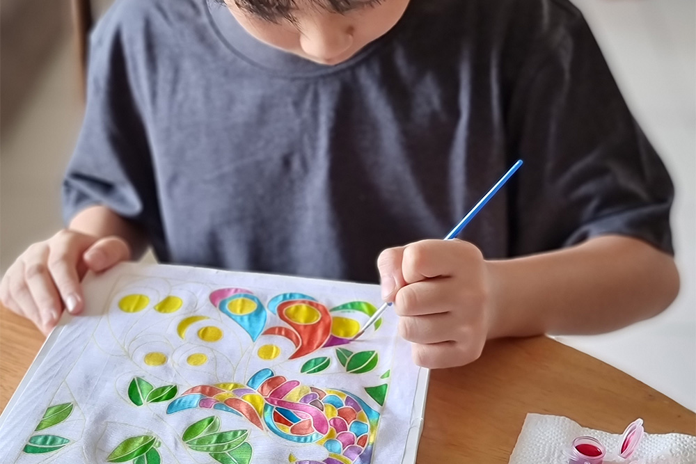  A kid painting at a workshop in The Jamjar 