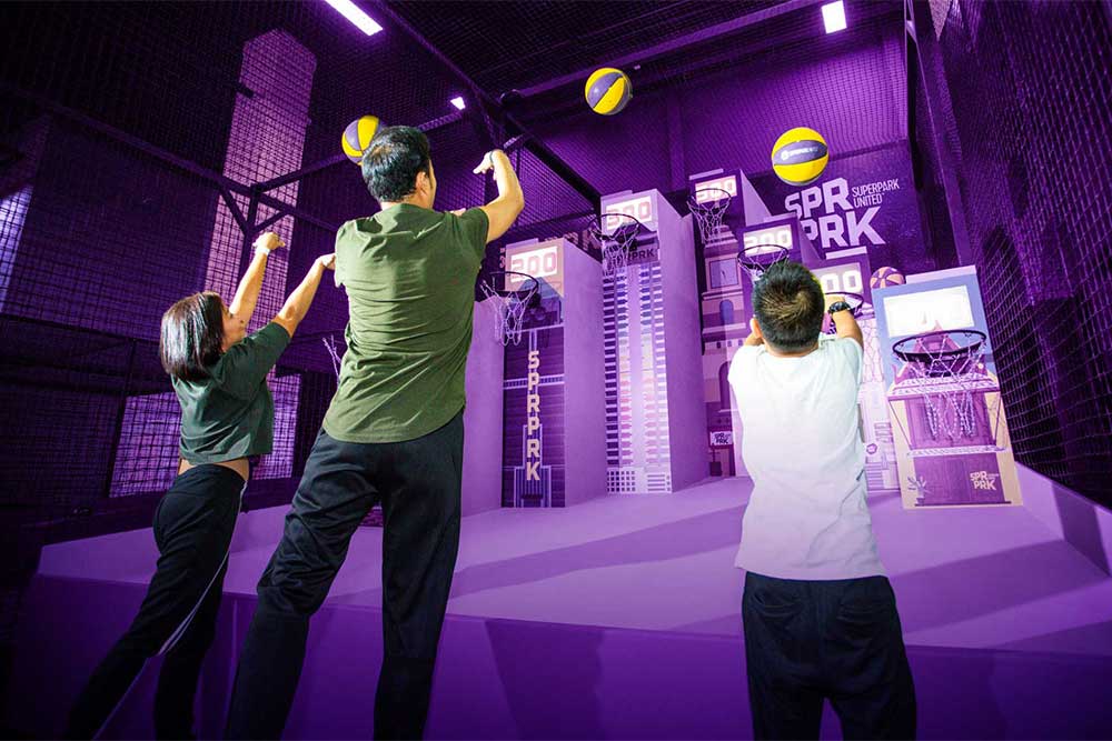 Children playing indoor basketball at an indoor park 