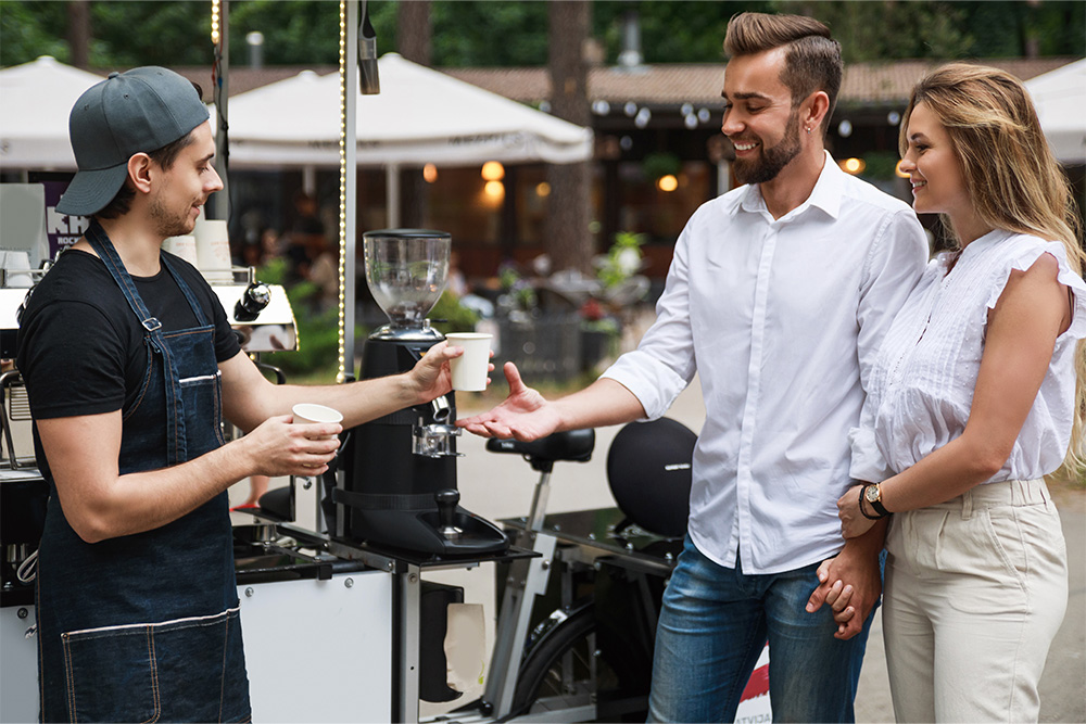 selling coffee at the movable coffee shop on the street.

