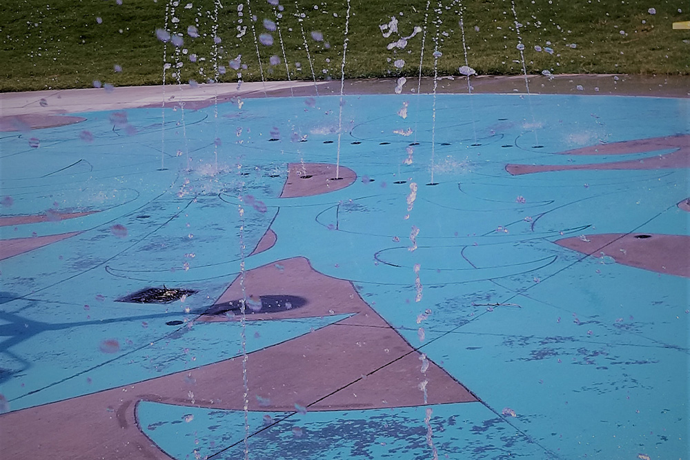 water sprinkling onto a splash pad