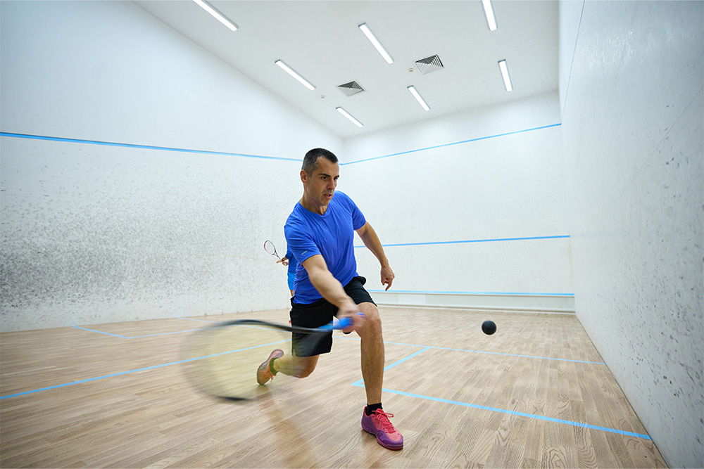 man serving in a squash game