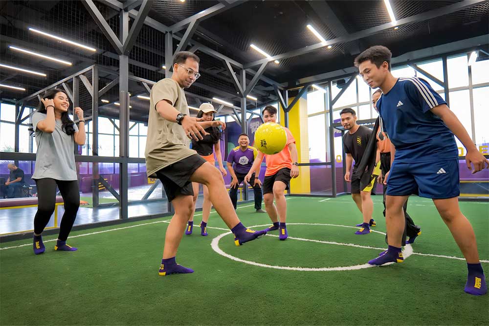 Corporate teams playing at an indoor park 