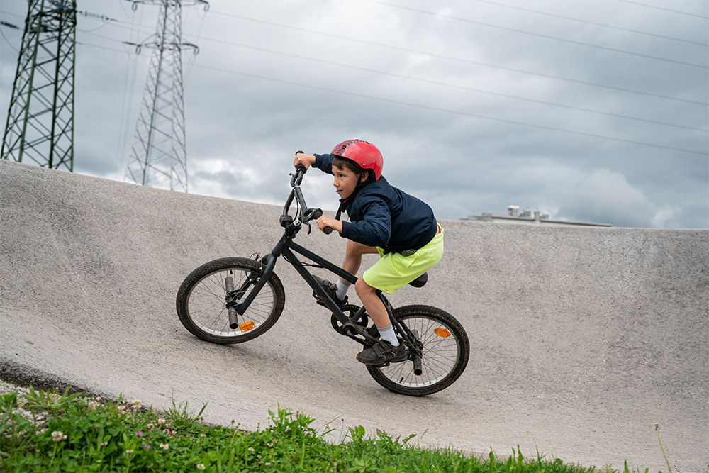 riding a bike on the pump track