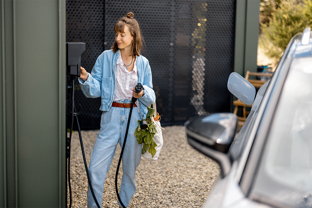 plugging charger in the car at a nearby charging station