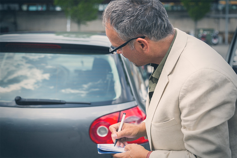 Man inspecting a car 