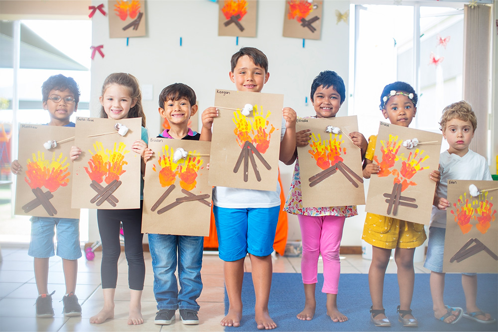 Children showcasing paintings in an art class in Dubai