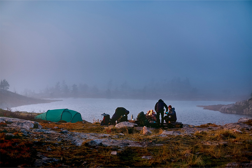 Campers enjoying a misty lakeside morning