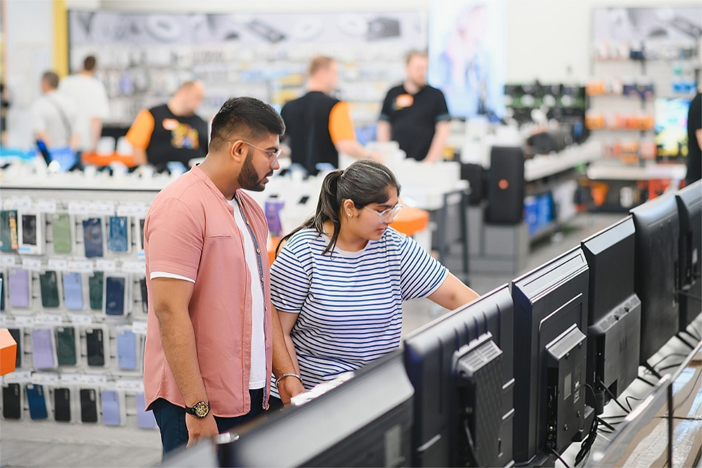 People checking out the appliances in the store