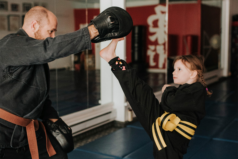 Coach and student practising kickboxing in the studio