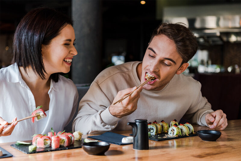 a couple eating sushi at 99 sushi bar