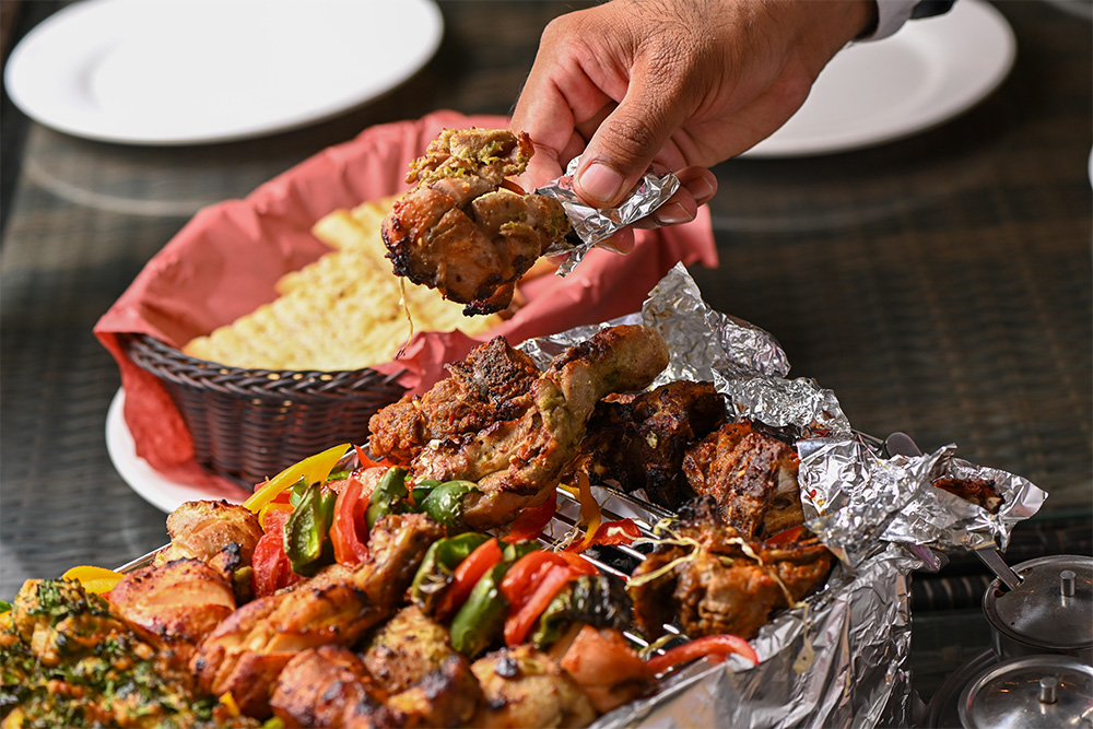 person eating kebab from a kebab platter in Sharjah