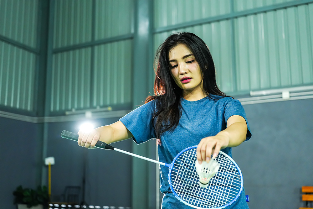 woman playing badminton