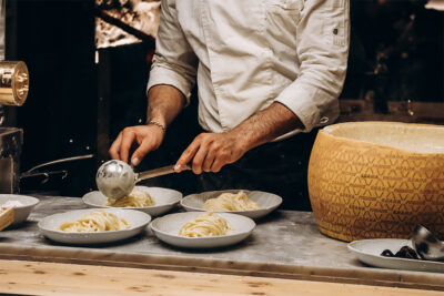 Chef plating Italian food at a restaurant