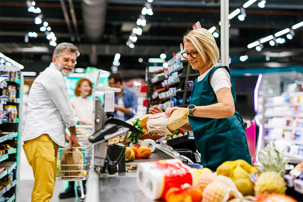 Cashiers packing groceries 