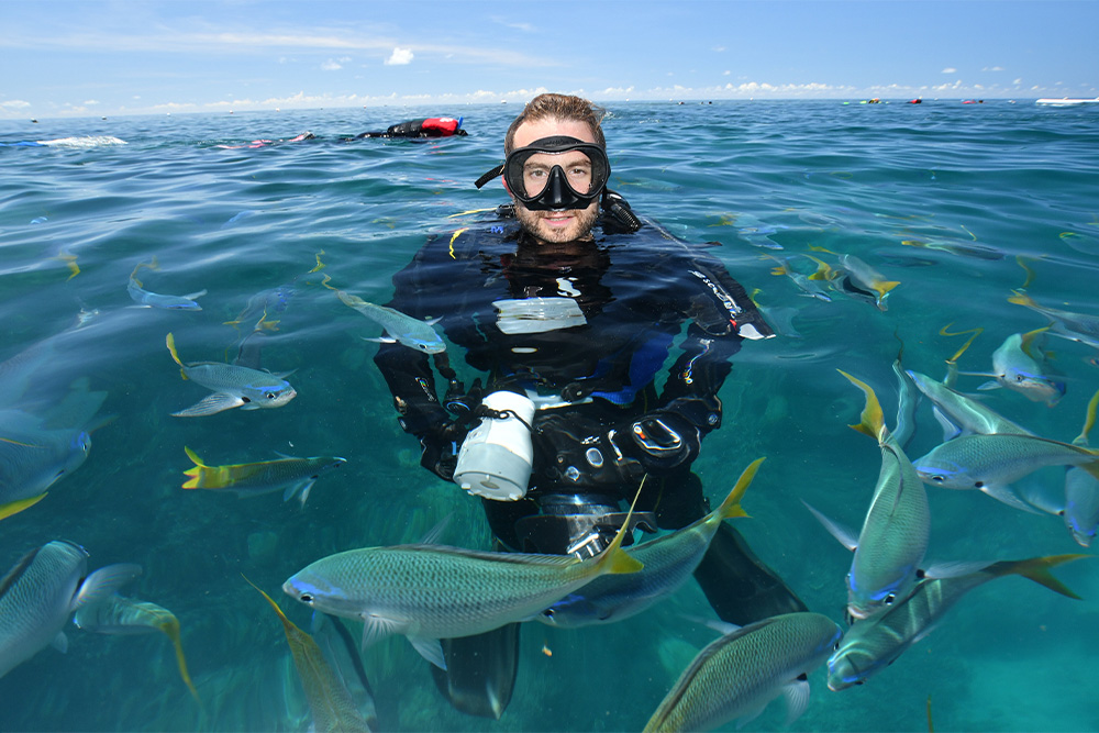 portrait of an underwater photographer above the water 