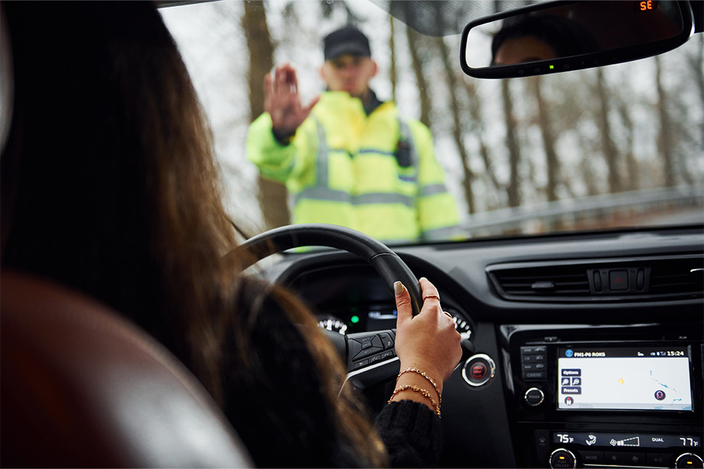 traffic police stopping a driver for penalties