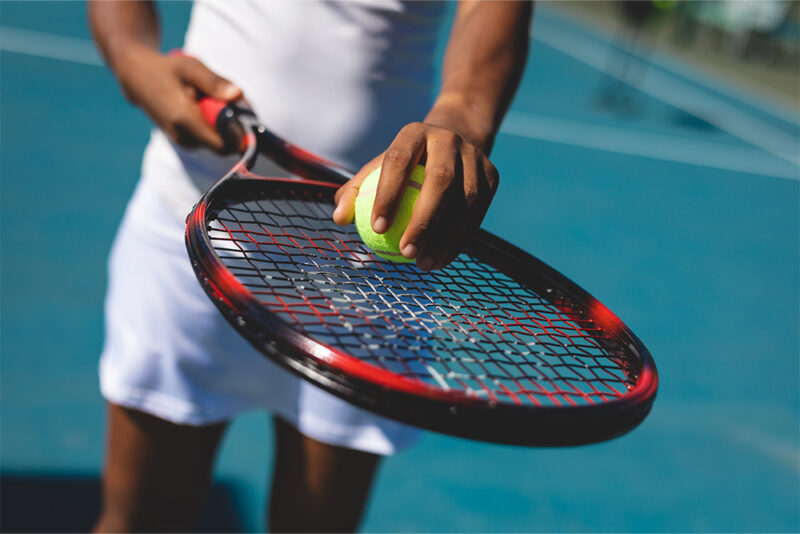 player ready to strike with tennis and ball