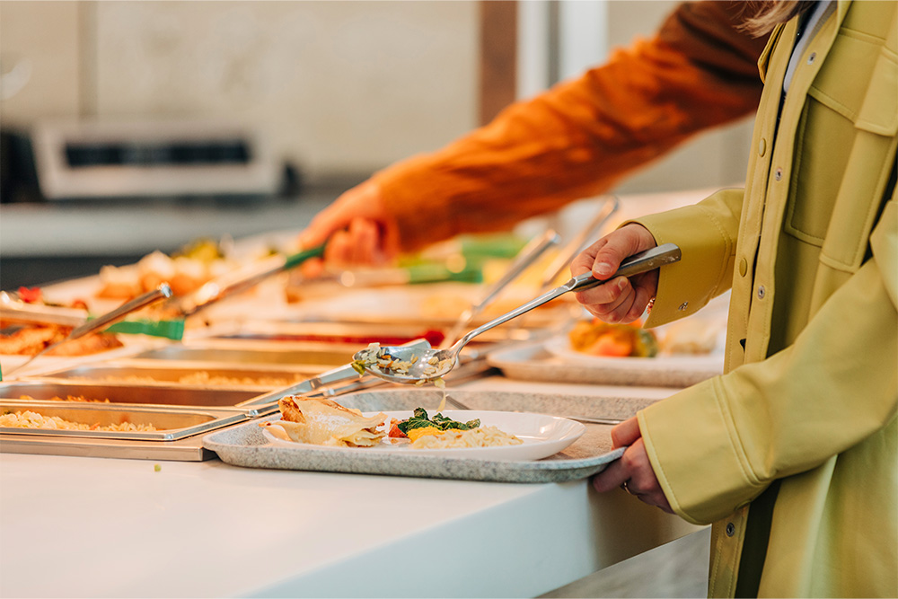 A women making her plate at the Buffet restaurant