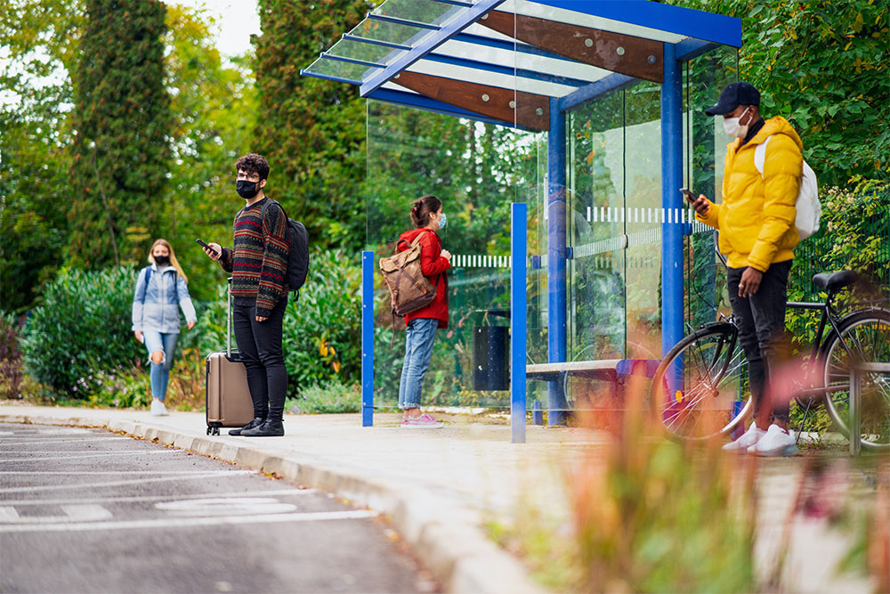 People waiting for a bus at a bus station