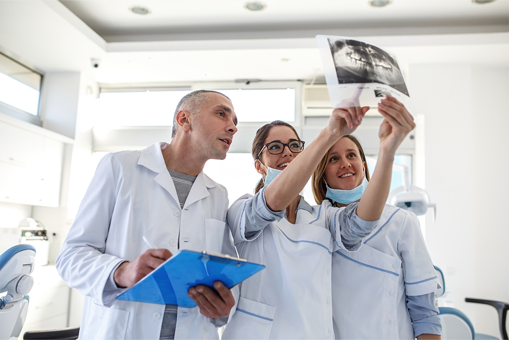 A team of dentists discussing a patient’s case in Sharjah