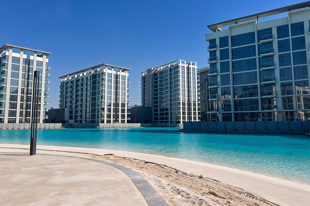 An infinity pool with buildings behind