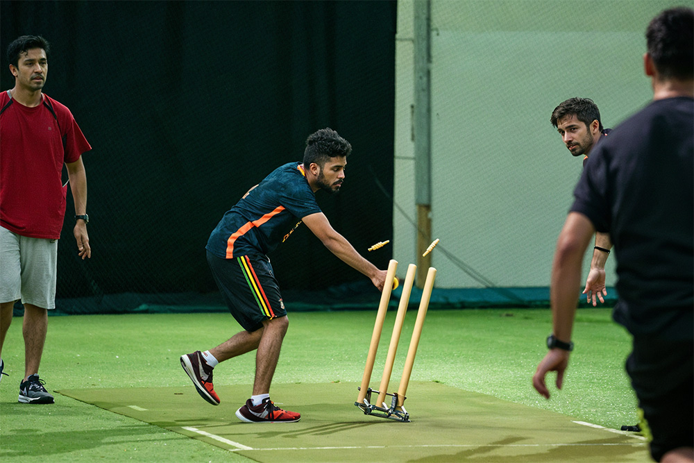 People playing cricket in an indoor cricket stadium in Dubai