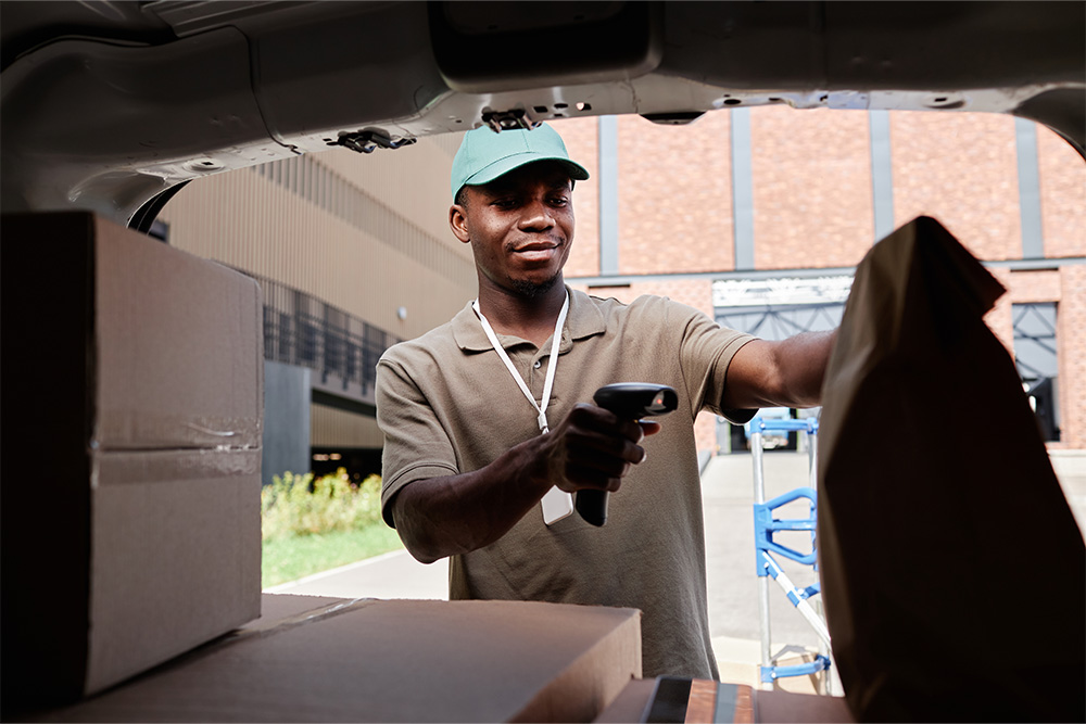 Delivery worker scanning code on packages 