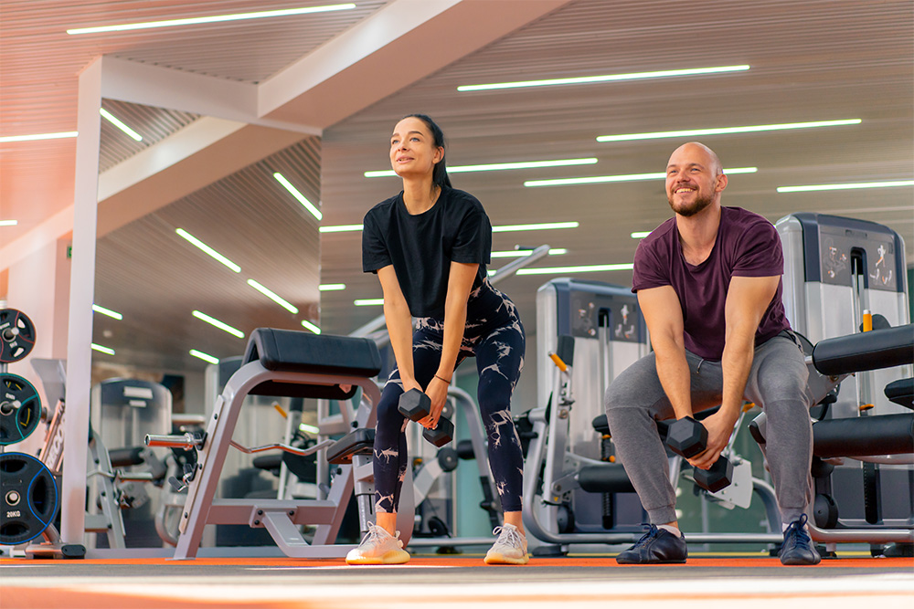 A trainer and woman doing group training