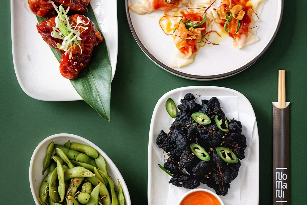 Korean food served on a table with chopsticks at Nomani Japanese/ Korean restaurant