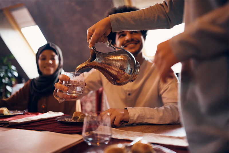 a waiter serving water at virginia angus restaurant