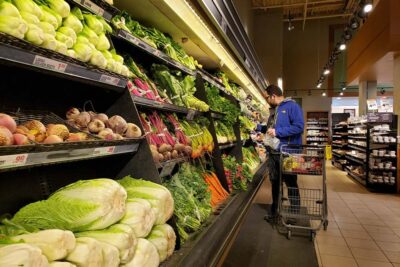 A man buying vegetables at Grandiose Supermarket Abu Dhabi