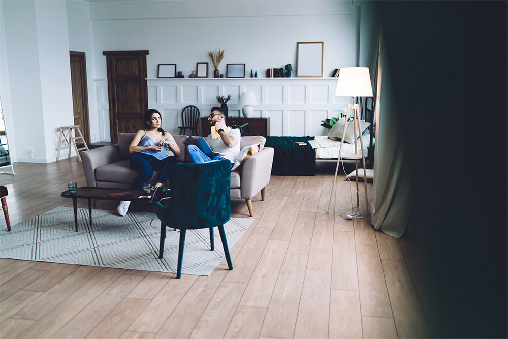 A couple lounging in a studio apartment 