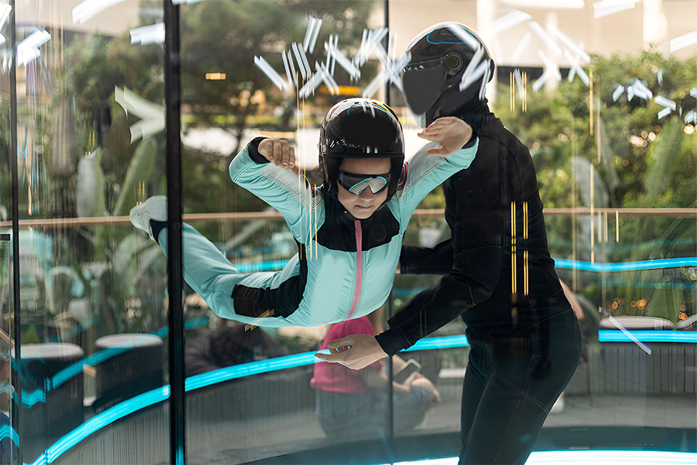 Instructor at iFLY Dubai guiding helping a girl to fly