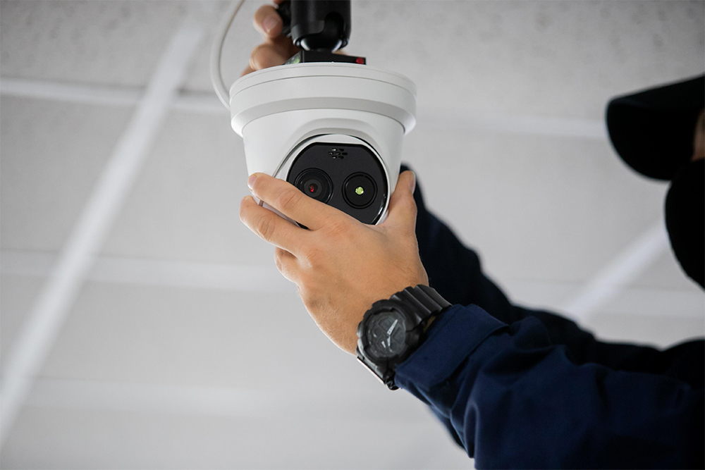 A man installing smart home security systems