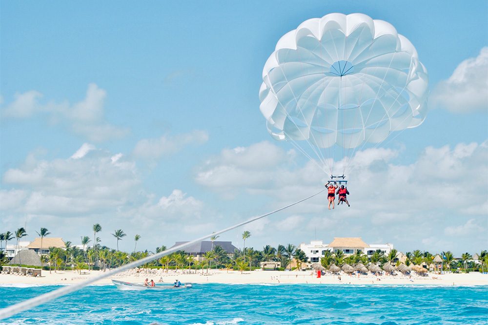 A couple parasailing with Sky & Sea Adventures