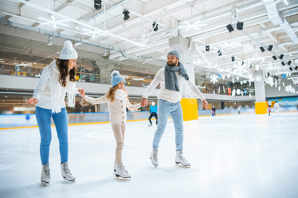 Family skating together in an Ice skating rink