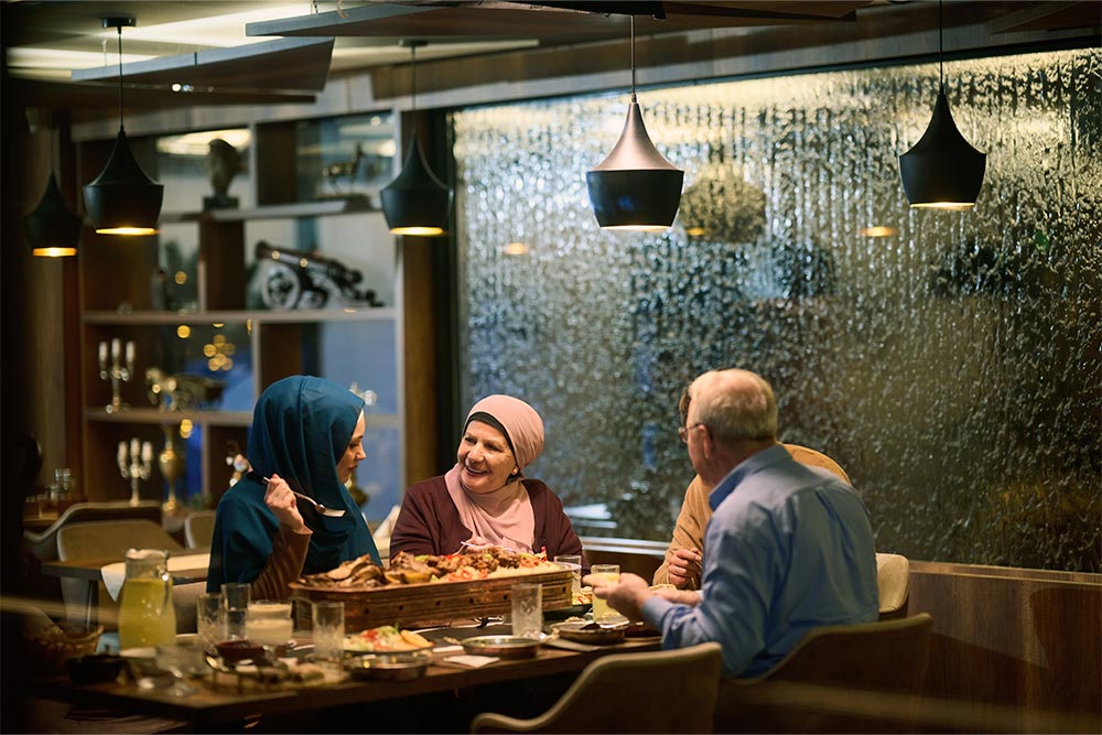 A family having dinner at a restaurant in Al Qurm