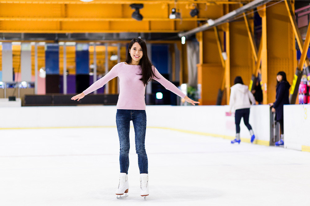 Woman balancing on an ice skating rink in Sharjah