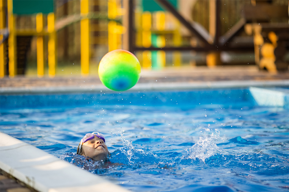 A young girl in the pool learning to swim