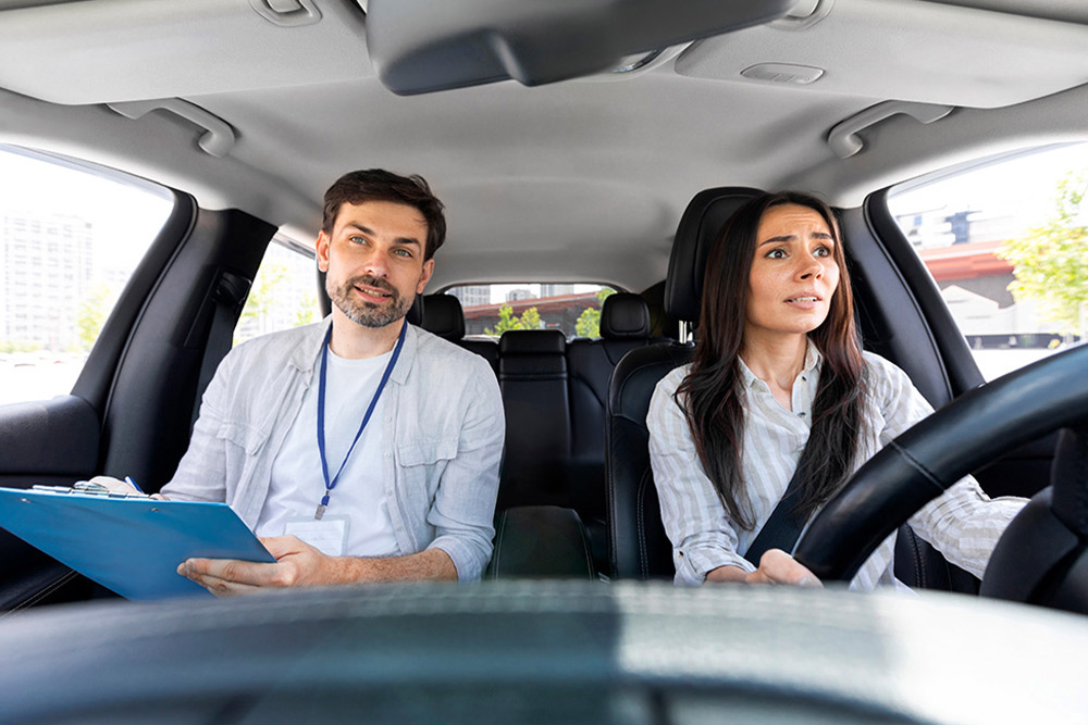 A learner driving with a satisfied instructor