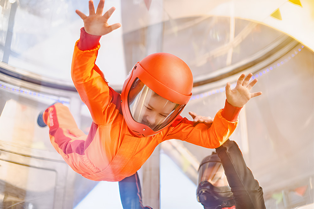 A kid flying at iFLY Dubai under supervision