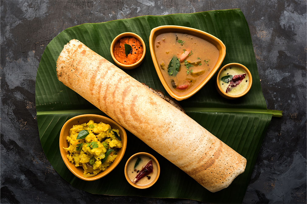 Masala dosa served on a banana leaf at an Indian restaurant in Ajman