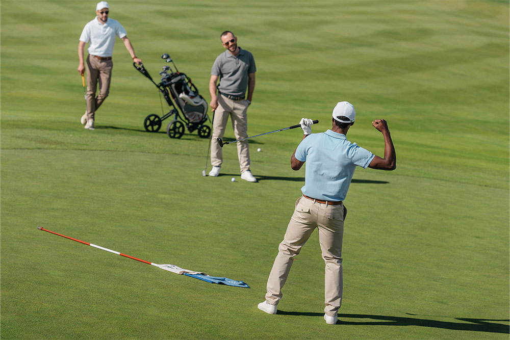 A group of friends playing golf in The Meadows