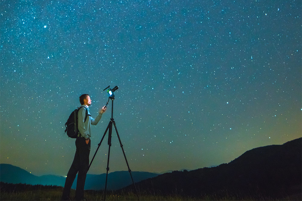 A man capturing the stargazing experiences with a camera