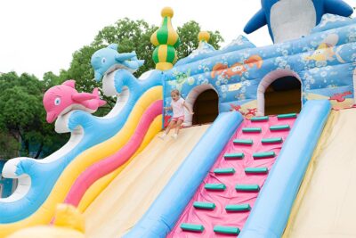 A girl at a bouncy slide at Funtastico