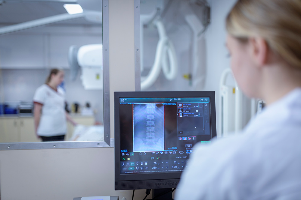 A radiologist overlooking a scan 