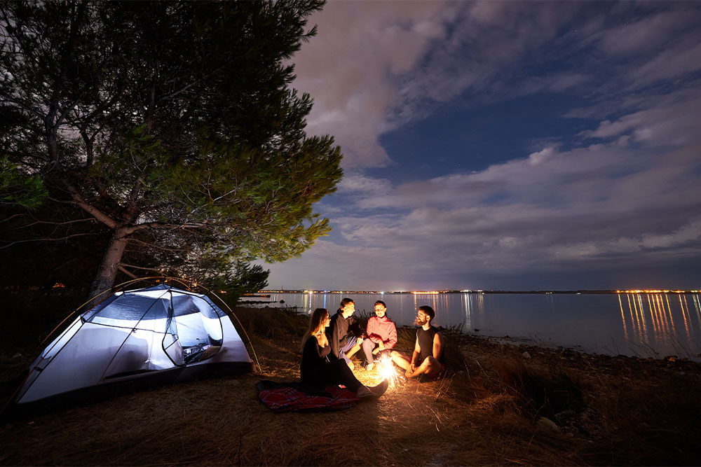 A group of friends camping overnight at RAK Beach